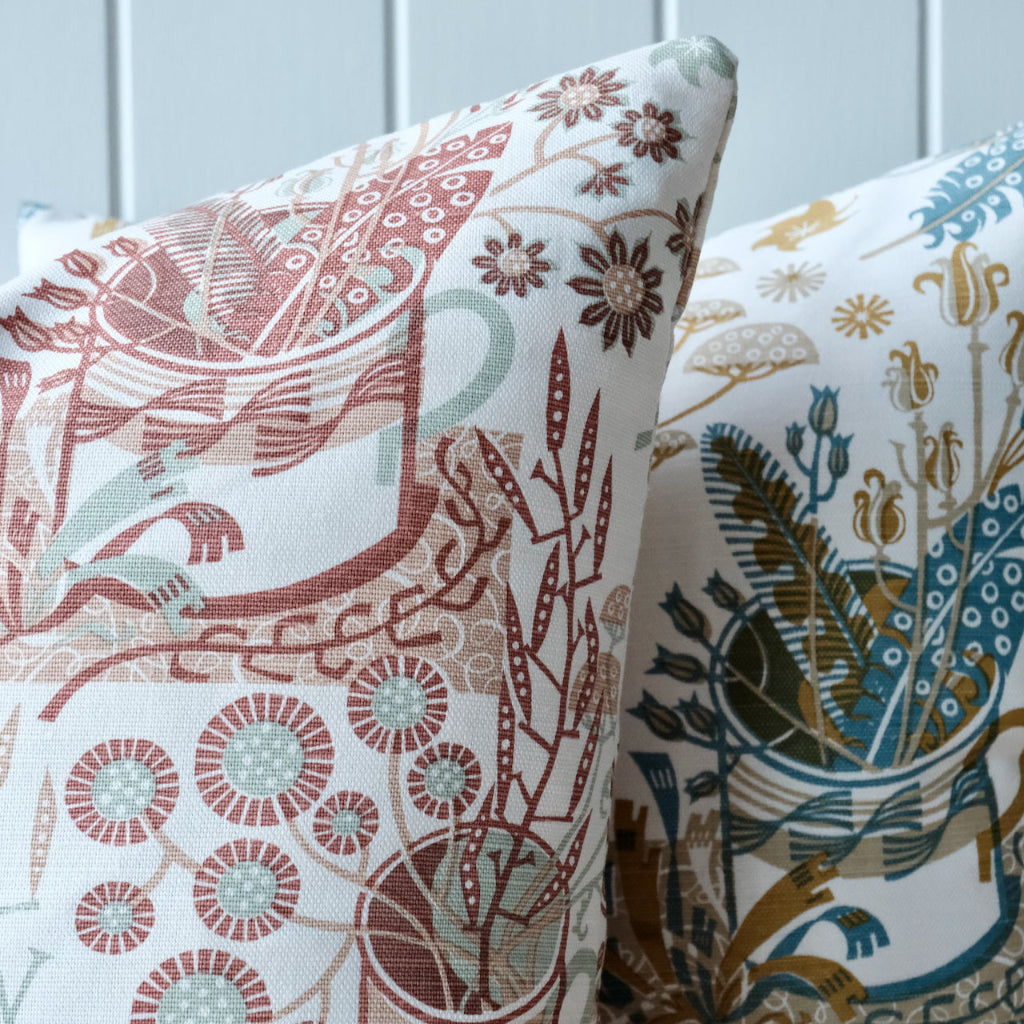 Two patterned pillows on a neutral background