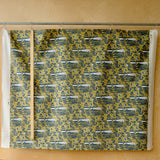 navy, white and yellow printed fabric in front of a plywood board