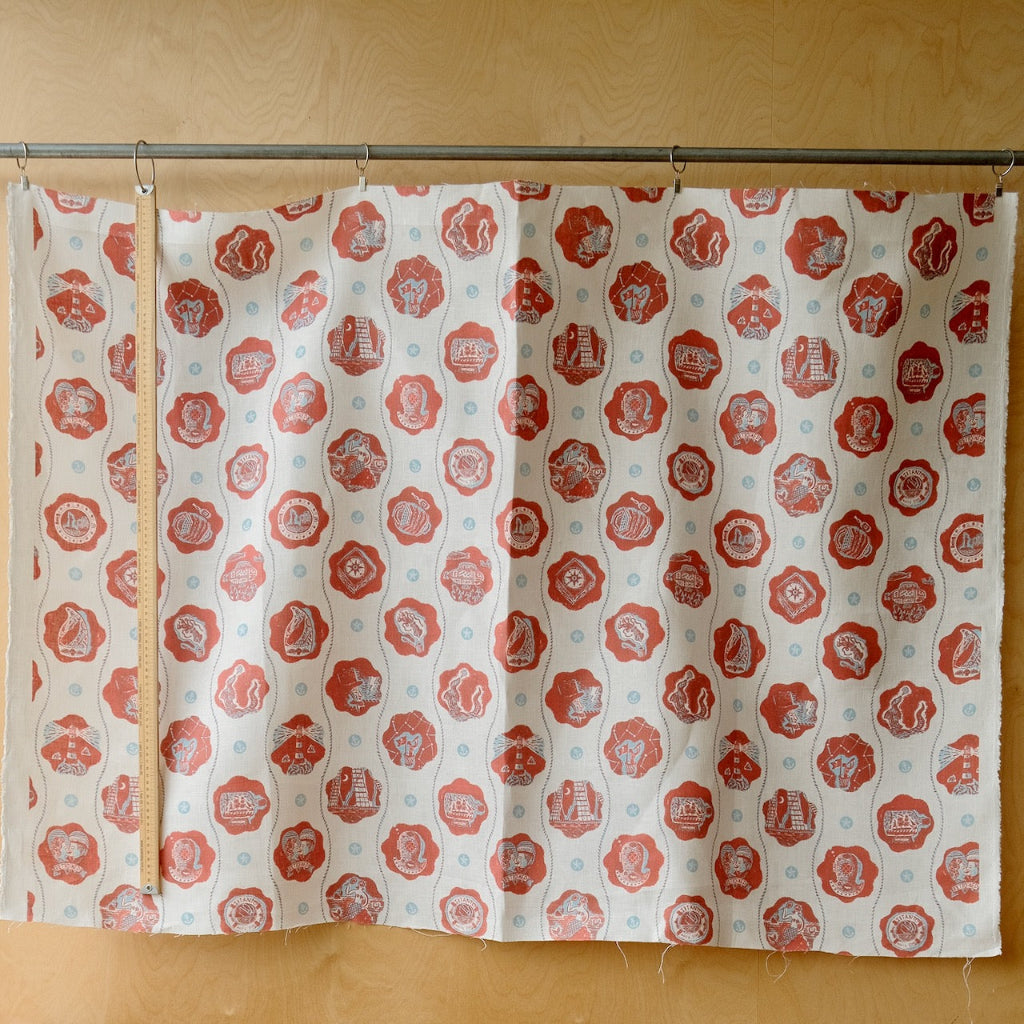 red and white patterned fabric infront of a plywood wall.