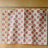 red and white patterned fabric infront of a plywood wall.