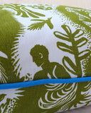 Decorative pillow with green and white pattern on a light background