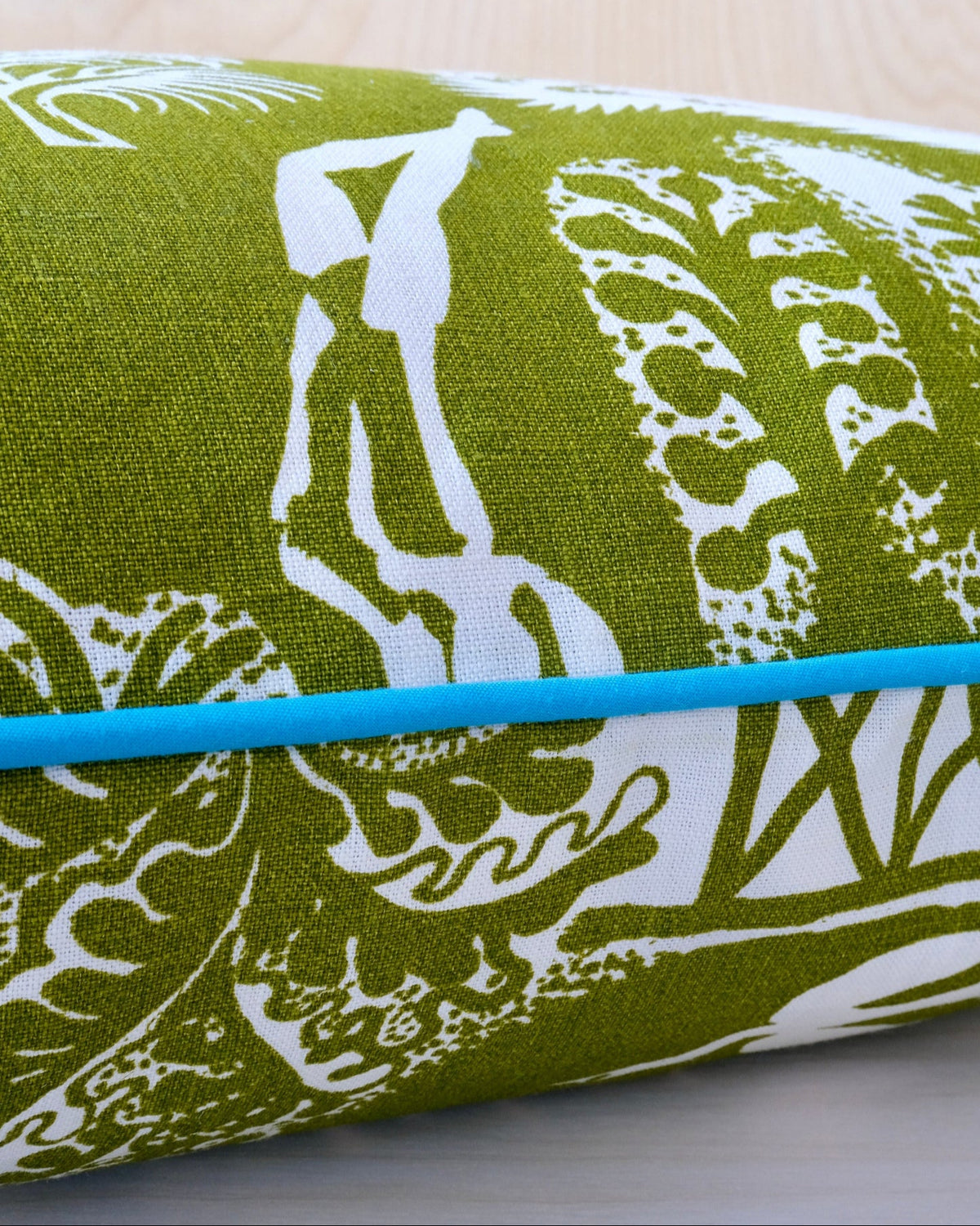 Green and white fabric with turquoise a wooden surface