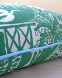 Green and white patterned cushion with pale blue piping.