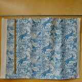 Fabric with blue animal pattern on a wooden background