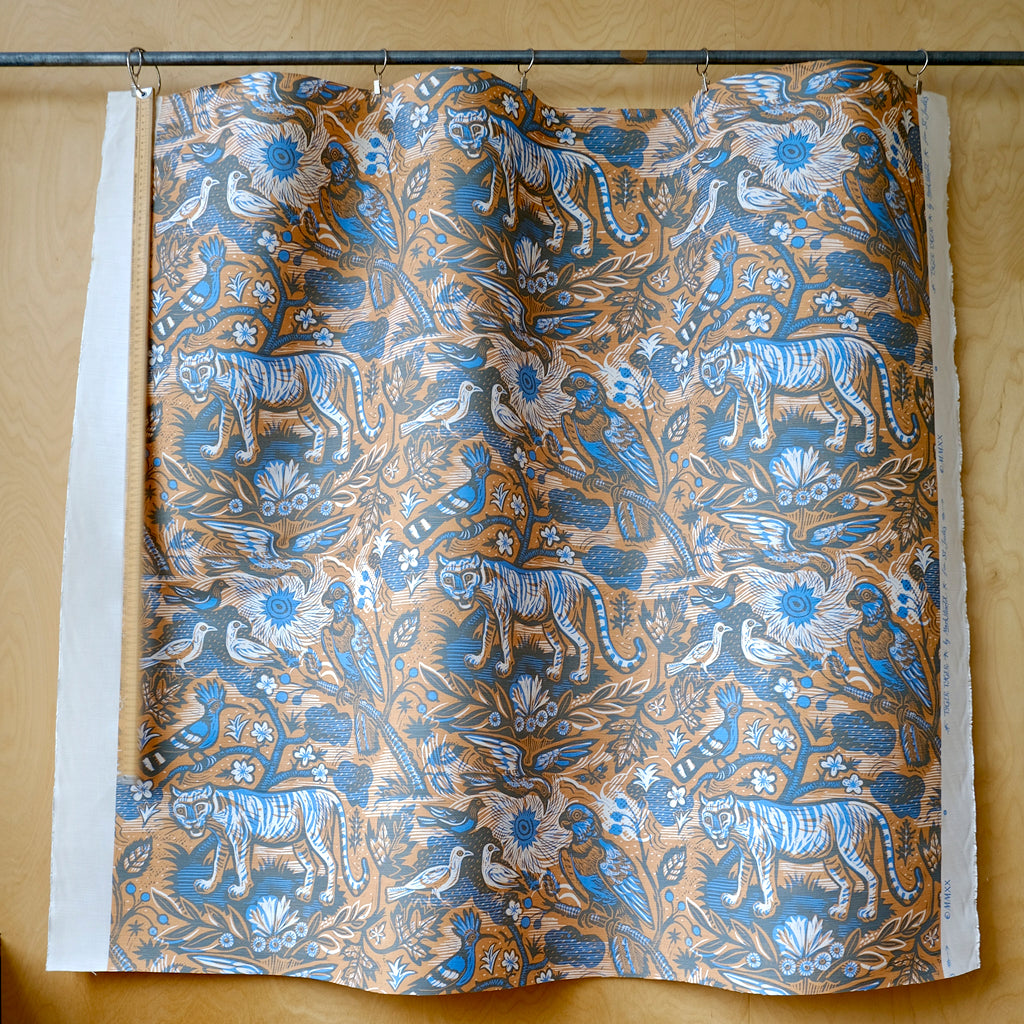 Blue and orange fabric with tiger, parrot, birds and plant designs